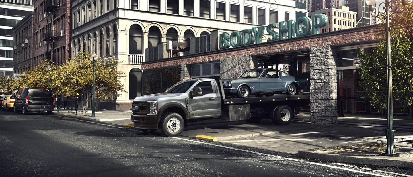 A 2023 Ford Super Duty® F-600® towing a classic car
