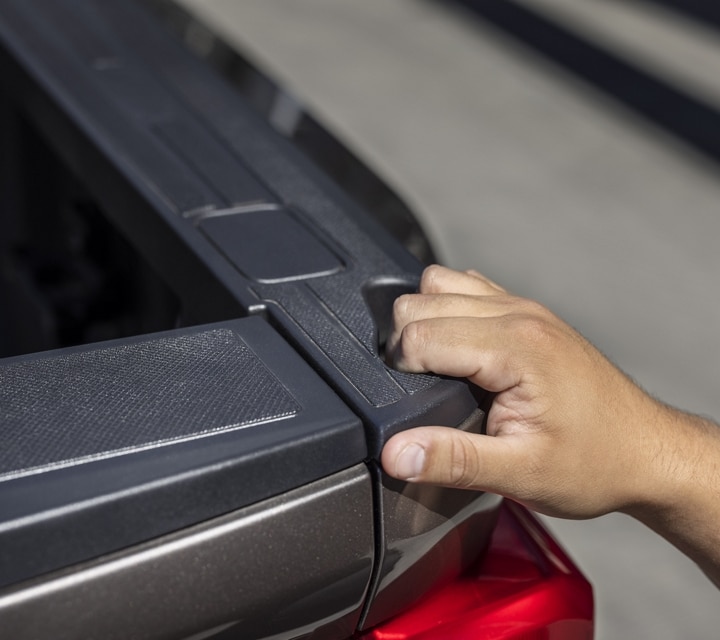 Close-up on a person grasping the truck bed hand pocket on a 2023 Ford Super Duty® truck